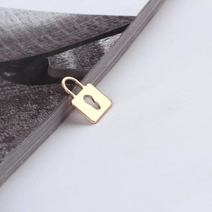 Detailed close-up of a polished gold-plated heart lock pendant for jewelry making