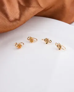 Detailed view of gold plated flower stud earring connector with loop for DIY jewelry