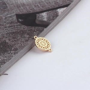 Detail of golden mandala style hollow lace circular charm connector for DIY jewelry