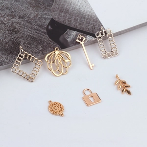 Set of gold alloy geometric charms including key, lock, and leaf for DIY jewelry making