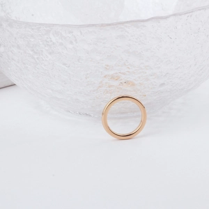 Minimalist rose gold geometric jewelry pendant with high polish finish on white surface