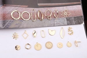 Detailed collection of assorted gold geometric charms and coin pendants for jewelry making
