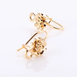 Macro detail of gold flower ear wire hooks with loops for DIY jewelry making accessories