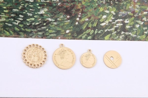 Detailed view of four golden coin pendants for DIY jewelry with Queen Elizabeth II motifs