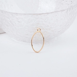 Close-up of golden oval alloy frame pendant for DIY jewelry making on white background