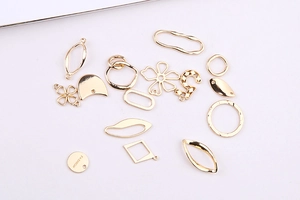 Detail of assorted gold-plated metal charms for DIY jewelry making in various shapes