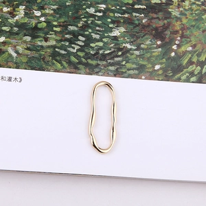 Detail of gold irregular oval metal ring with wavy texture for DIY jewelry making