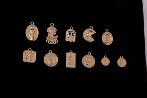 Detailed macro view of vintage gold coin pendants with embossed portraits on black velvet