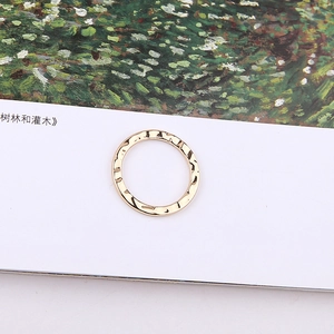 Detailed view of golden metal ring with textured hammered surface on artistic background