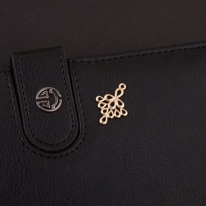 Detalle de un colgante geométrico de oro hueco con un intrincado diseño de alambre de metal