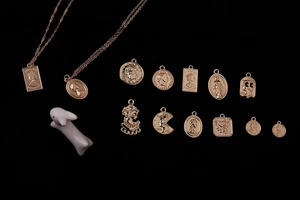 Detailed macro view of vintage alloy coin pendants and relief medallions for DIY jewelry