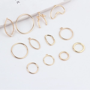 Golden alloy geometric branch and pearl charms for DIY jewelry making on white background