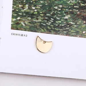 Artistic display of golden half-moon metal pendants for DIY jewelry making