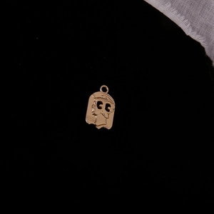 Detail view of a vintage gold alloy coin pendant with portrait relief and CC hollow design