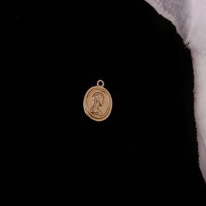Macro view of vintage gold oval pendant featuring a female relief head for DIY jewelry