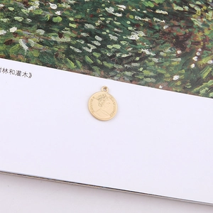 Detailed close-up of a gold coin pendant featuring Queen Elizabeth II for DIY jewelry