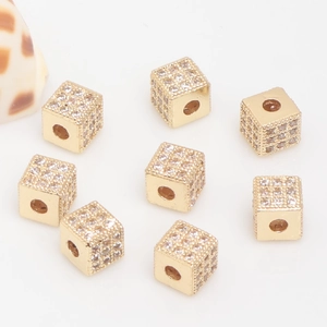 Macro view of 14k gold-filled cube spacer beads with pavé cubic zirconia for DIY jewelry