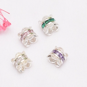 Detailed macro view of 14K gold-plated spacer beads with colorful zircon inlay for DIY jewelry