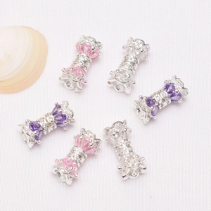 Detailed close-up of 14K gold plated clasp with micro-set zircon and colorful pearls