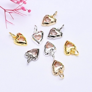 Detailed view of 14K gold-plated heart pendants with micro-pave pink cubic zirconia