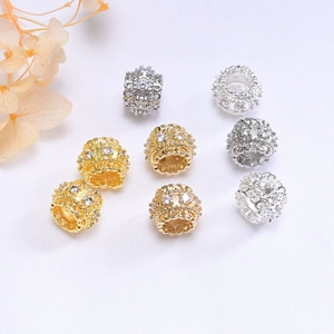 Macro detail of 10mm 14K gold plated hollow spacer beads with zircon for DIY bracelets