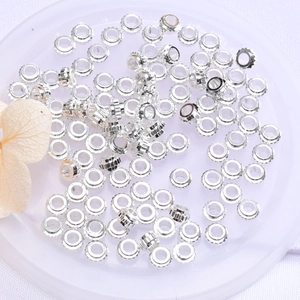 Polished silver color wheel spacer beads for DIY jewelry making on a white tray
