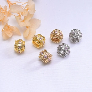 Close-up of 10mm 14K gold plated hollow spacer beads with pink zircon crystals