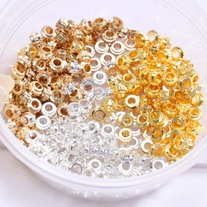 Detailed macro view of 14K gold plated wheel-shaped spacer beads for DIY jewelry making