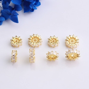 Macro detail of 14K gold plated wheel beads with clear cubic zirconia for DIY jewelry