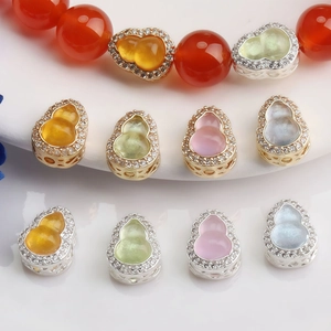 Detailed macro view of 14K gold-plated Wu Lou beads with faux jade and sparkling crystals