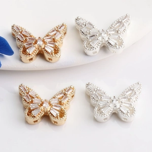 Macro shot of 14K gold butterfly beads with cubic zirconia for DIY jewelry making