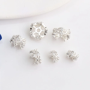 Macro shot of 14K gold-plated crown spacer beads with zircon inlays for jewelry making