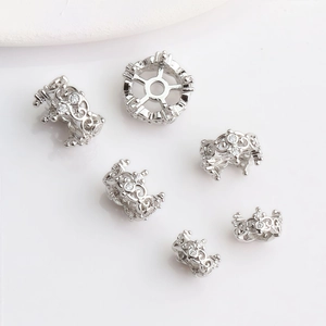 Detailed view of silver crown bead spacers with zircon inlays for DIY jewelry