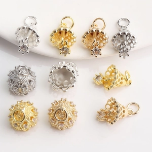 Detailed macro of gold and silver crown bell charms with sparkling zircon for DIY jewelry