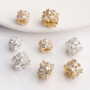 Macro detail of 14K gold plated barrel beads with sparkling cubic zirconia for DIY jewelry