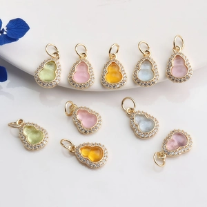 Macro detail of 14K gold plated Wu Lou pendants with micro-set cubic zirconia stones