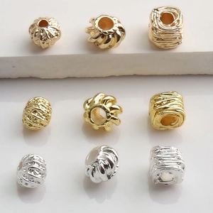 Macro shot of 14K gold and silver plated pumpkin spacer beads for DIY jewelry making