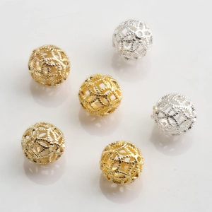 Detailed view of 10mm hollow metal spacer beads with woven texture in gold and silver