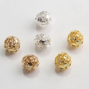 Macro detail of 10mm hollow gold and silver plated beads for DIY jewelry making