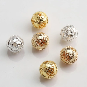 Detailed view of 10mm hollow gold and silver plated beads with geometric pattern for jewelry