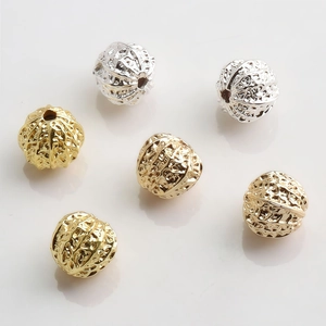 Detailed view of 10mm gold and silver hollow flower beads for DIY jewelry making