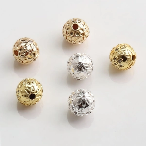 Macro shot of 10mm gold and silver hollow floral spacer beads for jewelry making