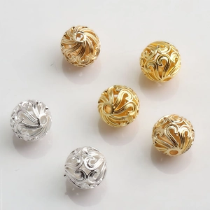 Macro detail of 10mm hollow gold and silver plated spacer beads for DIY jewelry making