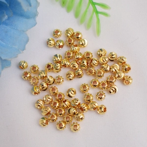 Dettaglio macro di perline melone placcate oro 14k per creazione di gioielli fai-da-te