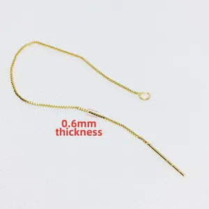 Detailed view of 0.6mm gold-plated box chain ear thread with needle and jump ring