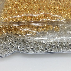 Macro shot of 14k gold-filled and silver hollow filigree beads for DIY jewelry making