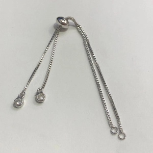 Dettaglio di bracciale a catena regolabile in argento con cursore micro-pavé e ciondoli