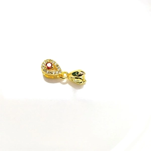 Macro detail of 18k gold plated bail with cubic zirconia and red main stone