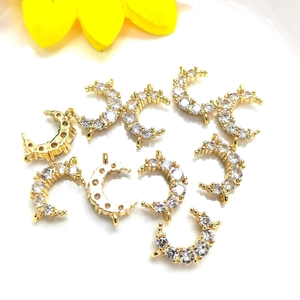 Detailed view of 14K gold plated moon pendants with micro-pave cubic zirconia crystals
