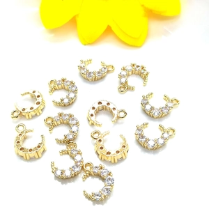 Detailed view of 14K gold-plated crescent moon charms with micro-paved cubic zirconia gems
